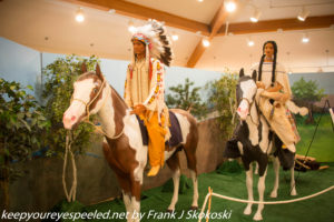 Native American couple on horse pack in traditional attire 