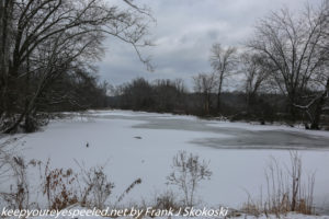 snow and ice covered pond