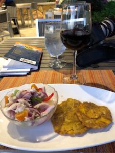 ceviche and monfongo and a glass of wine 