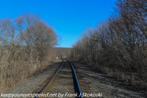 railroad track trees and blue sky