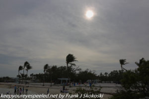sun obscured by clouds on beach 